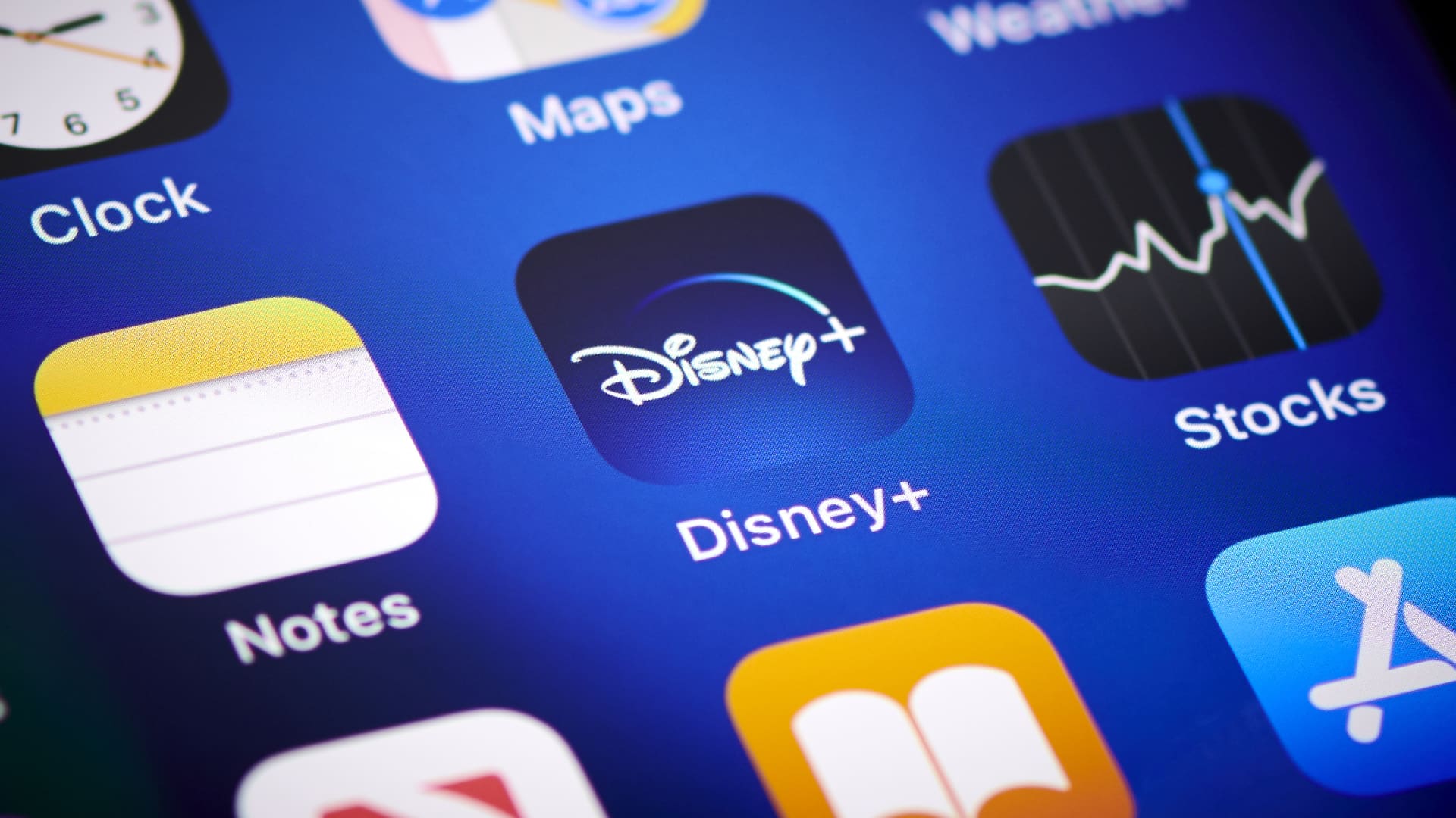 Close-up detail of the Disney+ app icon on an Apple iPhone 12 Pro smartphone screen.