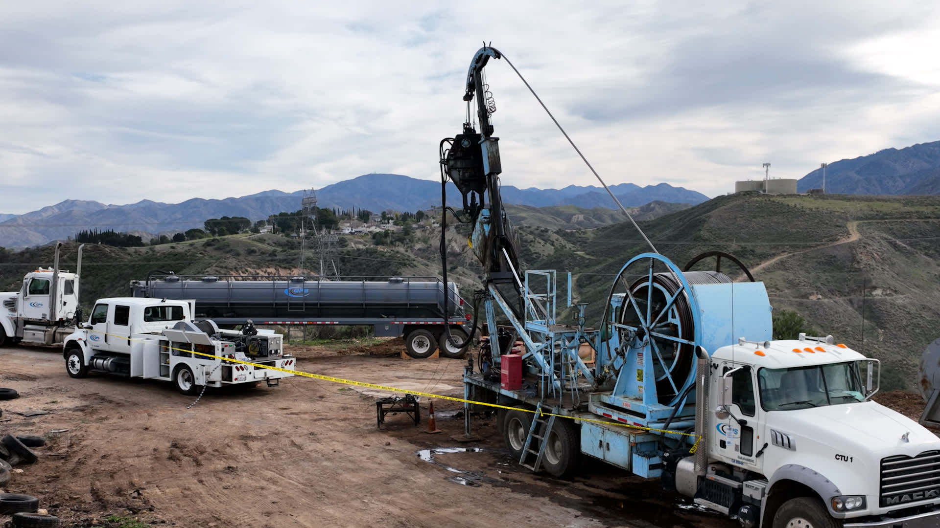 Work trucks and rigs at the Placerita Oil Field in northern Los Angeles County, where the California Geologic Energy Management Division is plugging 56 orphaned oil and gas wells.