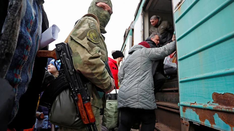 A militant of the self-proclaimed Donetsk People's Republic is seen on a platform, as evacuees board a train before leaving the separatist-controlled city of Donetsk, Ukraine February 22, 2022.