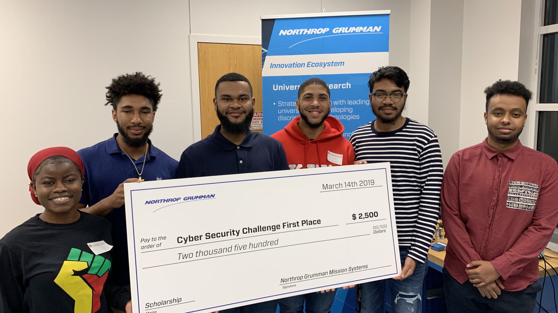 Favour Nerrise (L) stands with the University of Maryland NSBE chapter cyber security challenge winners