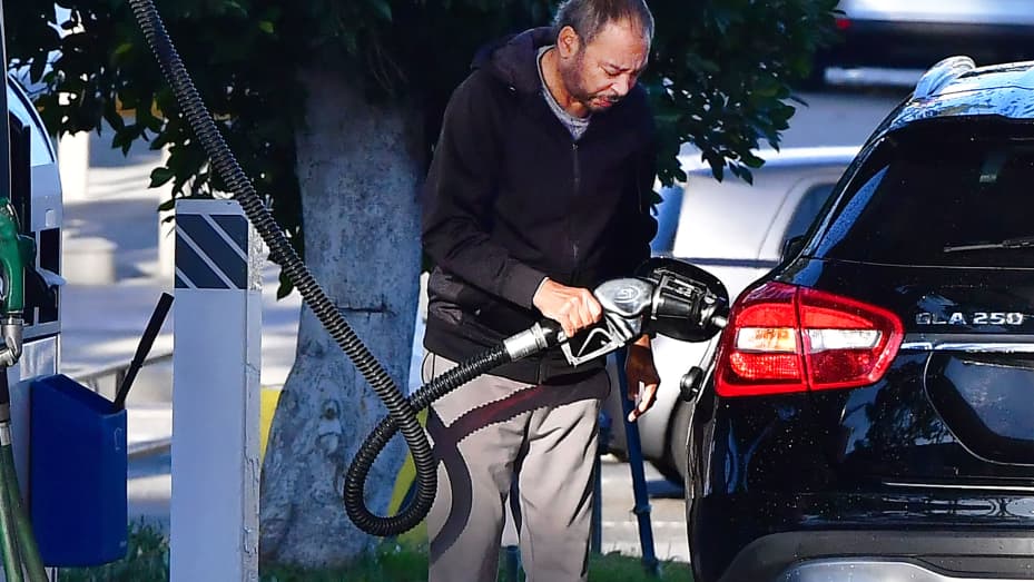 A man pumps gas into his vehicle at a petrol station in Montebello, California on February 23, 2022, as gas prices hit over $6 dollars per gallon.