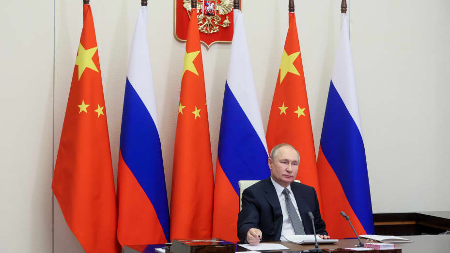Russia's President Vladimir Putin is seen in his office in the Novo-Ogaryovo residence during a bilateral meeting with China's President Xi Jinping via a video call in Dec. 2021.