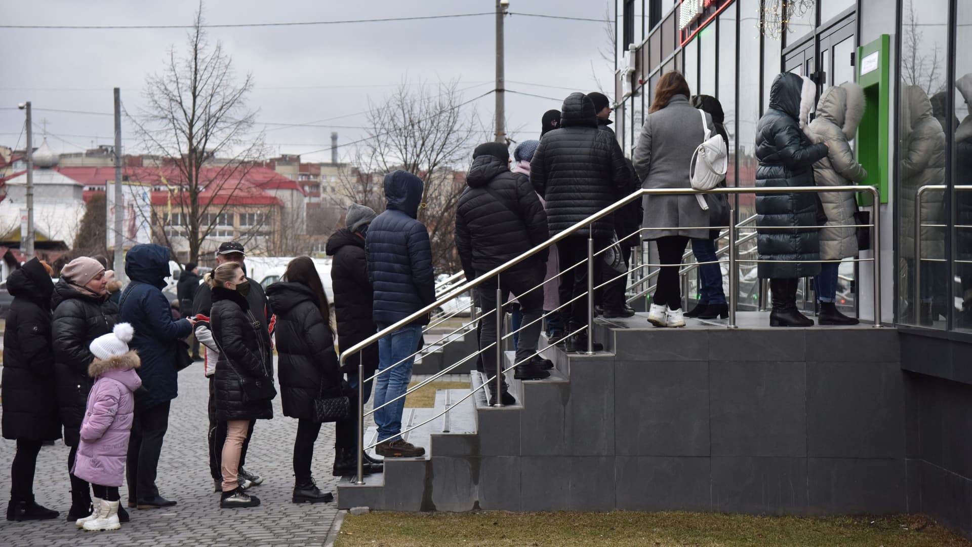 People queue at an ATM after Russian President Vladimir Putin authorized a military operation in eastern Ukraine, in Lviv, Ukraine February 24, 2022.