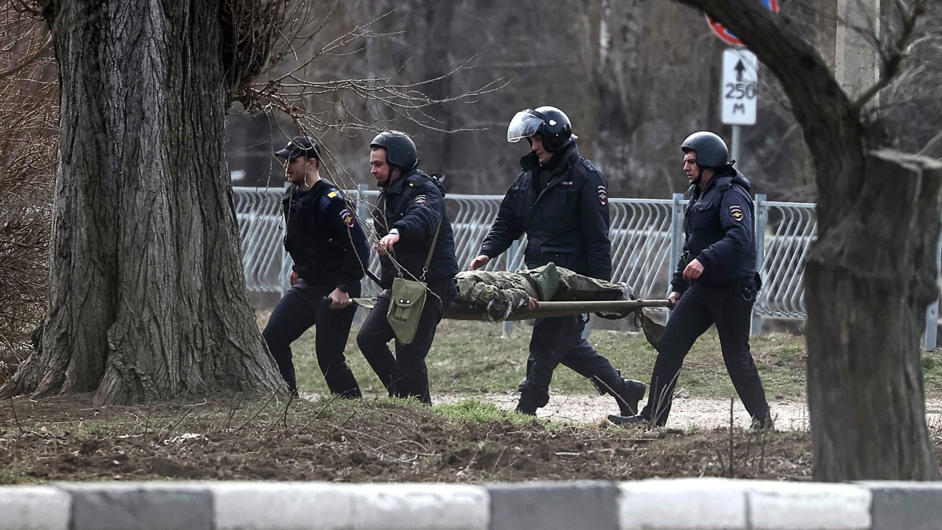 Police officers carry a serviceman on a stretcher in the town of Armyansk, northern Crimea.