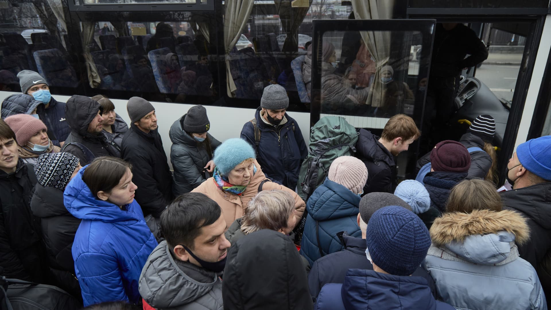 People board a bus as they attempt to evacuate the city on February 24, 2022 in Kyiv, Ukraine.