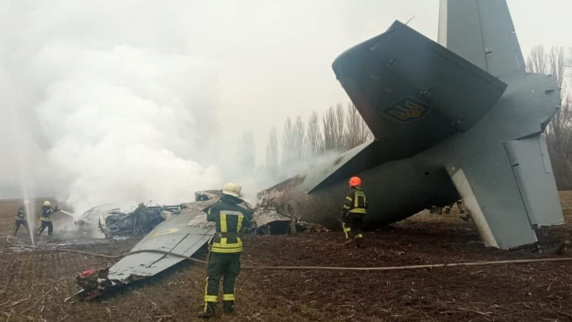Rescuers work at the crash site of the Ukrainian Armed Forces' Antonov aircraft, which, according to the State Emergency Service, was shot down in Kyiv region, Ukraine, in this handout picture released February 24, 2022.