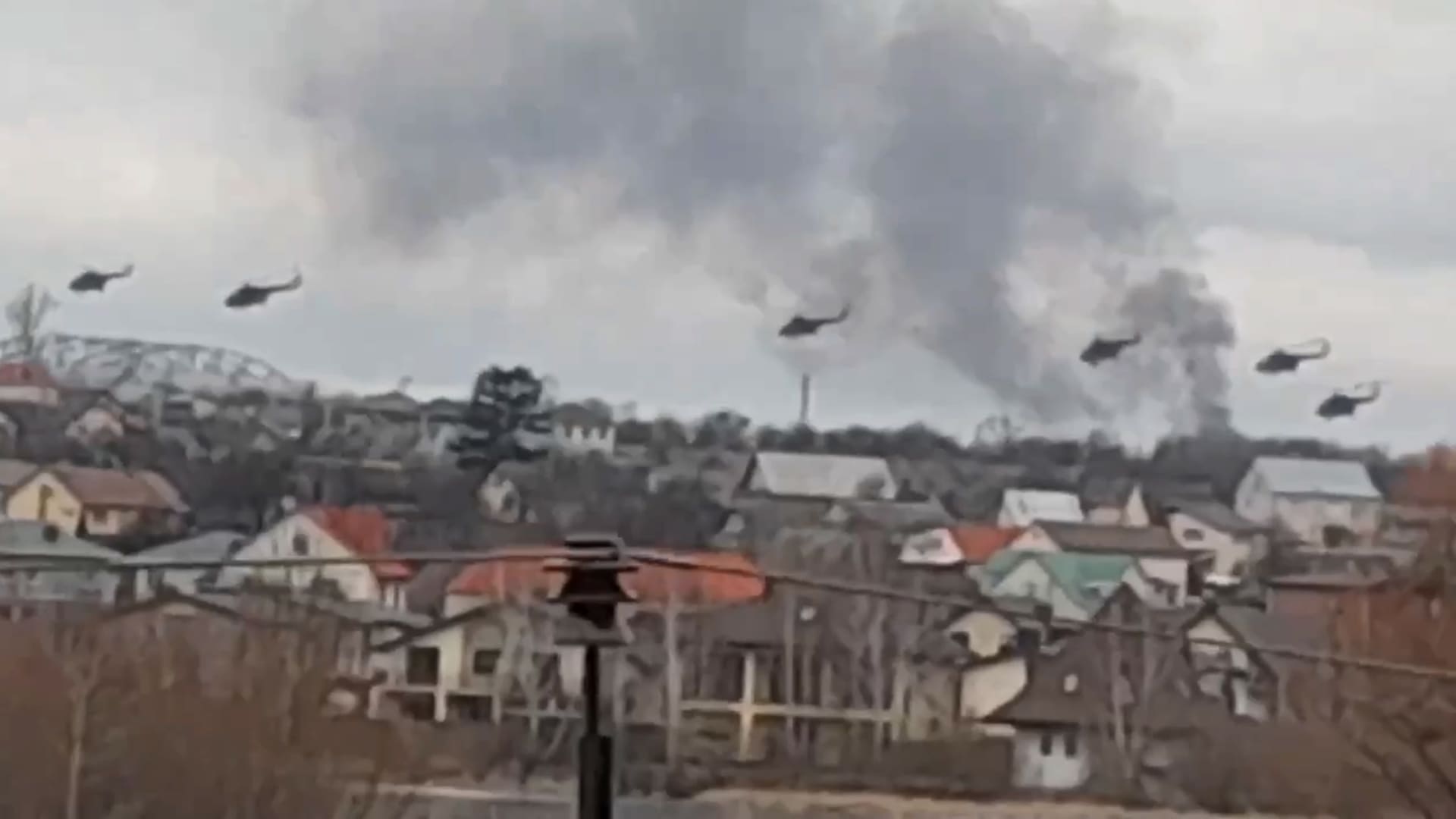 In this handout photo taken from video released by Ukrainian Police Department Press Service, Military helicopters apparently Russian, fly over the outskirts of Kyiv, Ukraine, Thursday, Feb. 24, 2022.