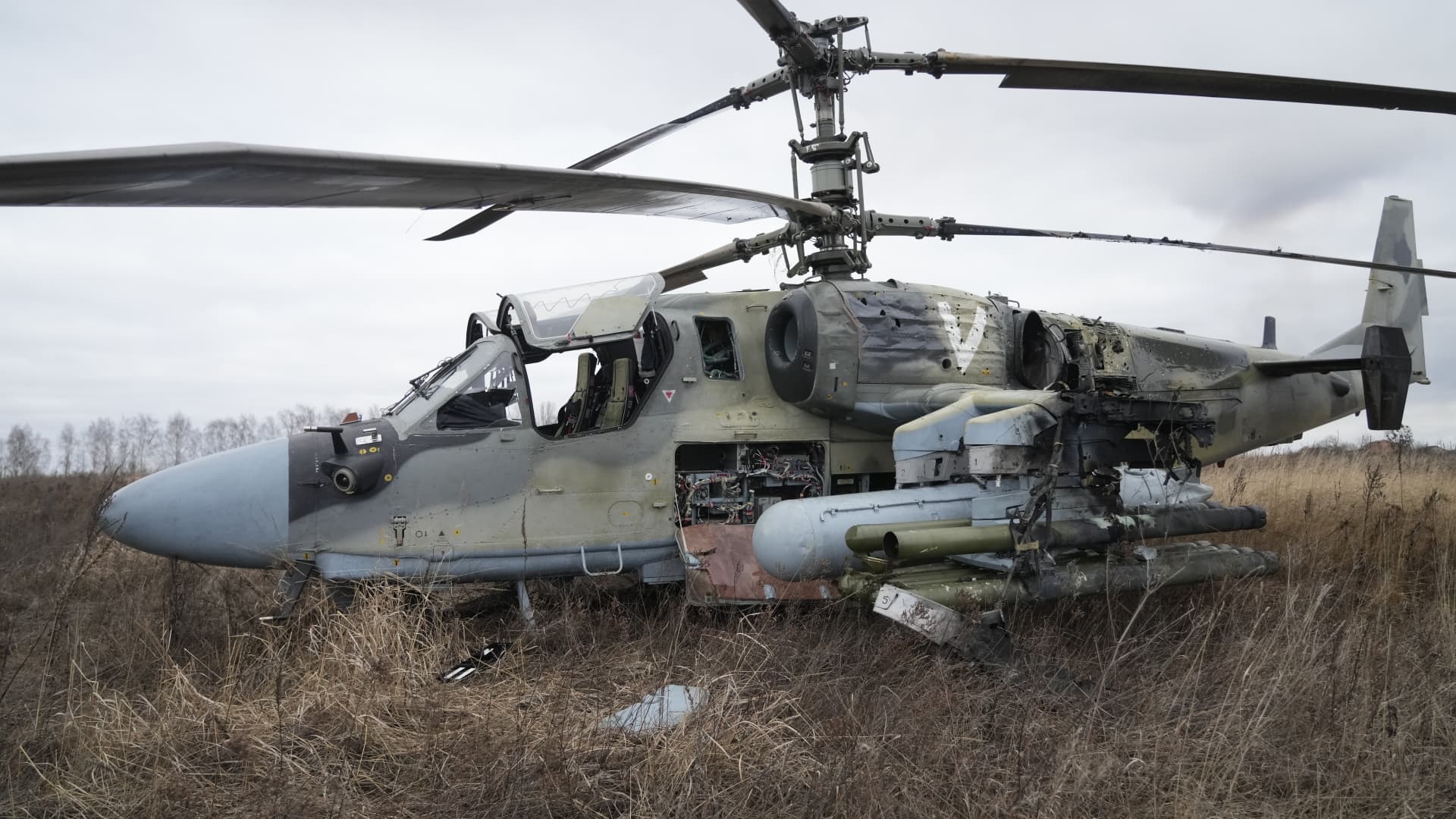 A Russian Ka-52 helicopter gunship is seen in the field after a forced landing outside Kyiv, Ukraine, Thursday, Feb. 24, 2022.