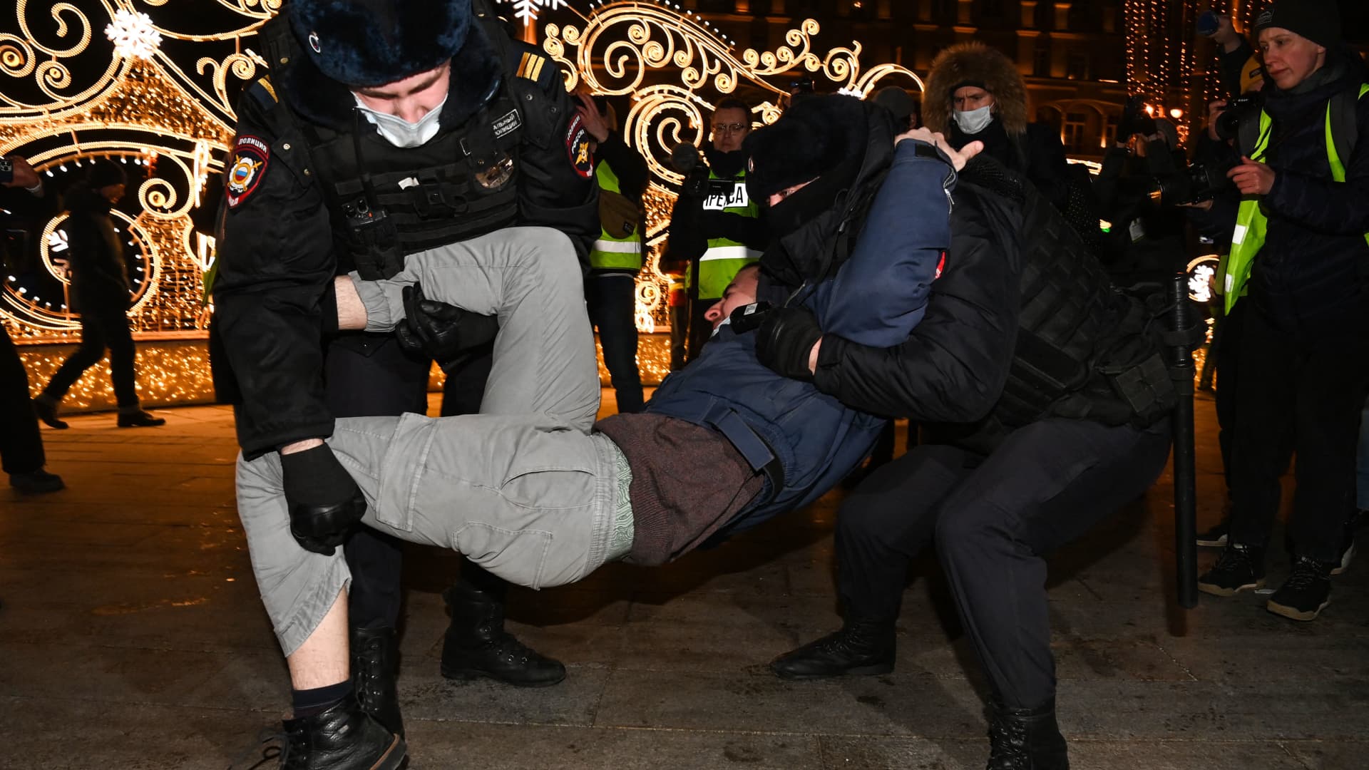 Police officers detain a man during a protest against Russia's invasion of Ukraine in Moscow on February 24, 2022.