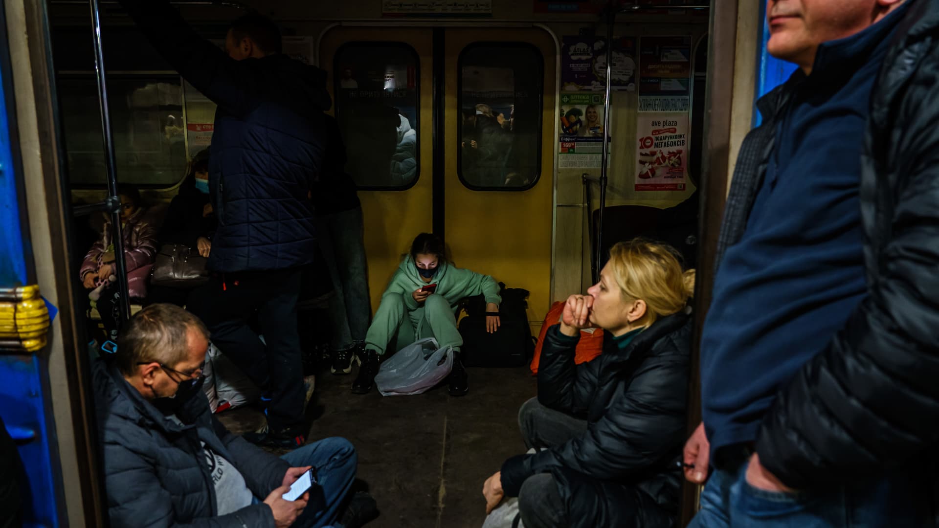 Hundreds of people seek shelter underground, on the platform, inside the dark train cars, and even in the emergency exits, in metro subway station as the Russian invasion of Ukraine continues, in Kharkiv, Ukraine, Thursday, Feb. 24, 2022.