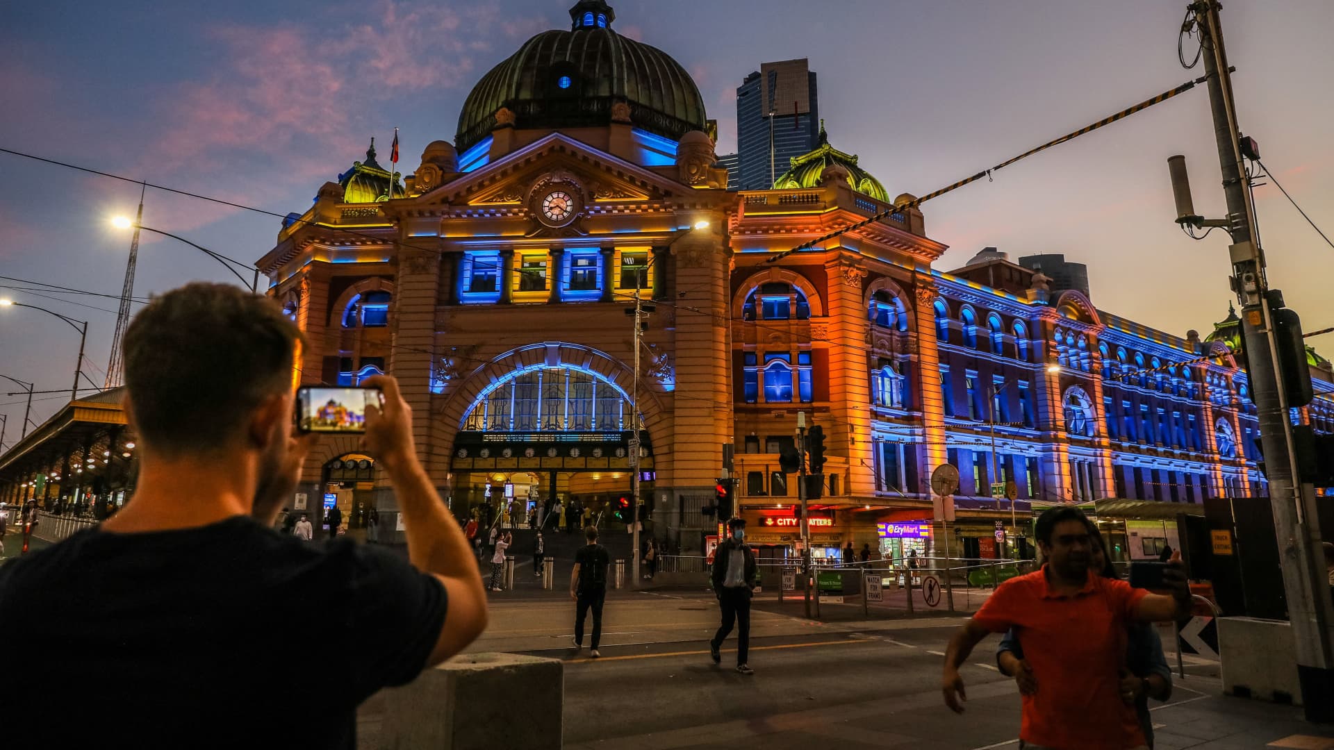 A general view of Flinders Street Station as it is lit in yellow and blue in Melbourne on February 24, 2022, as public buildings lit up in the national colours of Ukraine as a show of support.