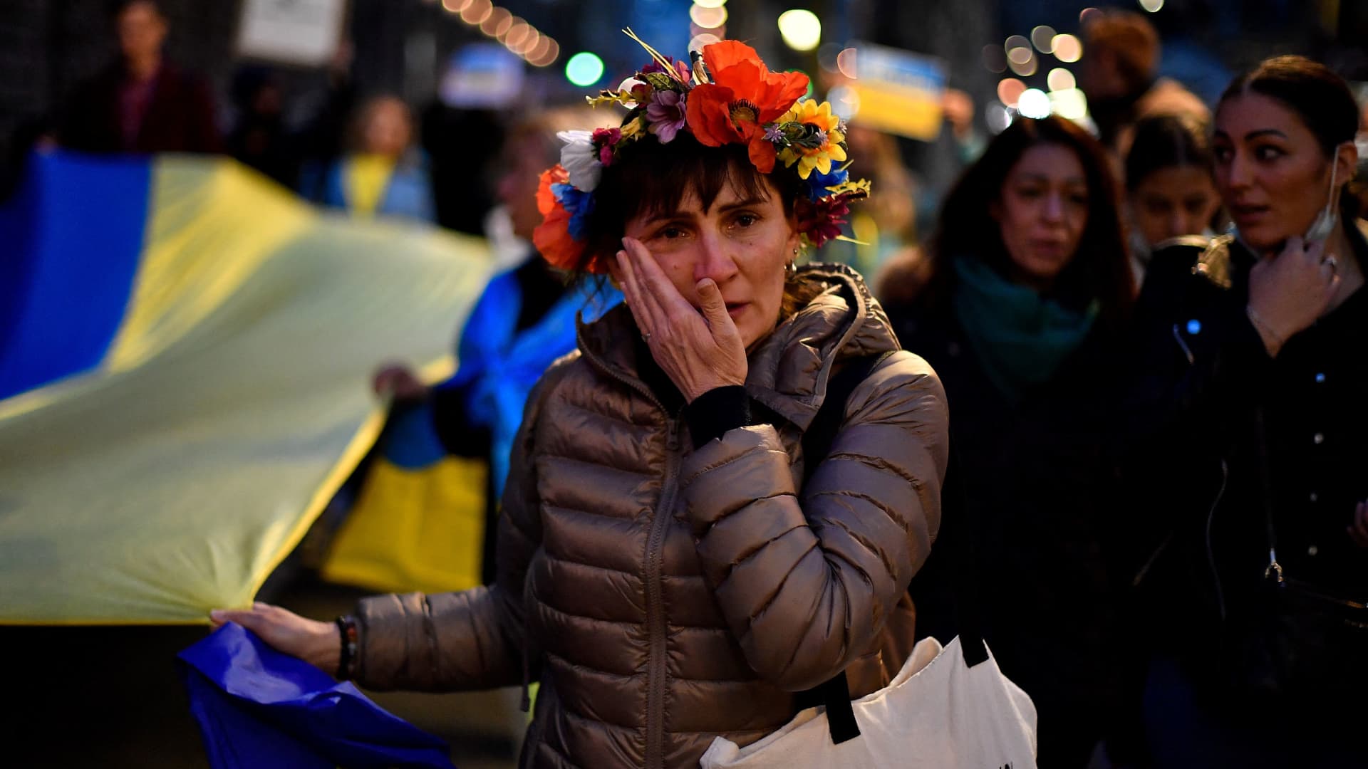 A demonstrator cries during a protest against Russia's military operation in Ukraine, in Barcelona on February 24, 2022.