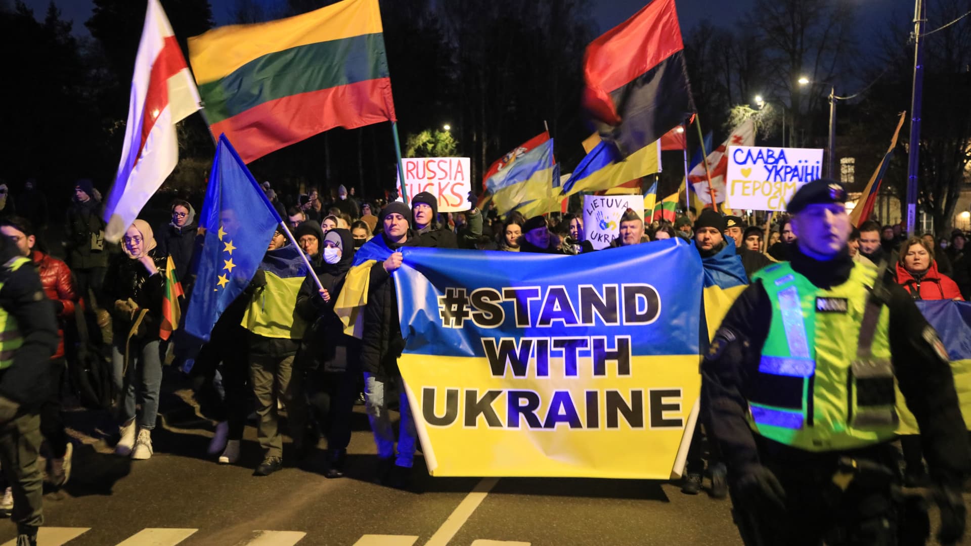 Demonstrators take part in a protest against the Russian invasion of Ukraine, in front of Russia's embassy in Vilnius, Lithuania, on February 24, 2022.
