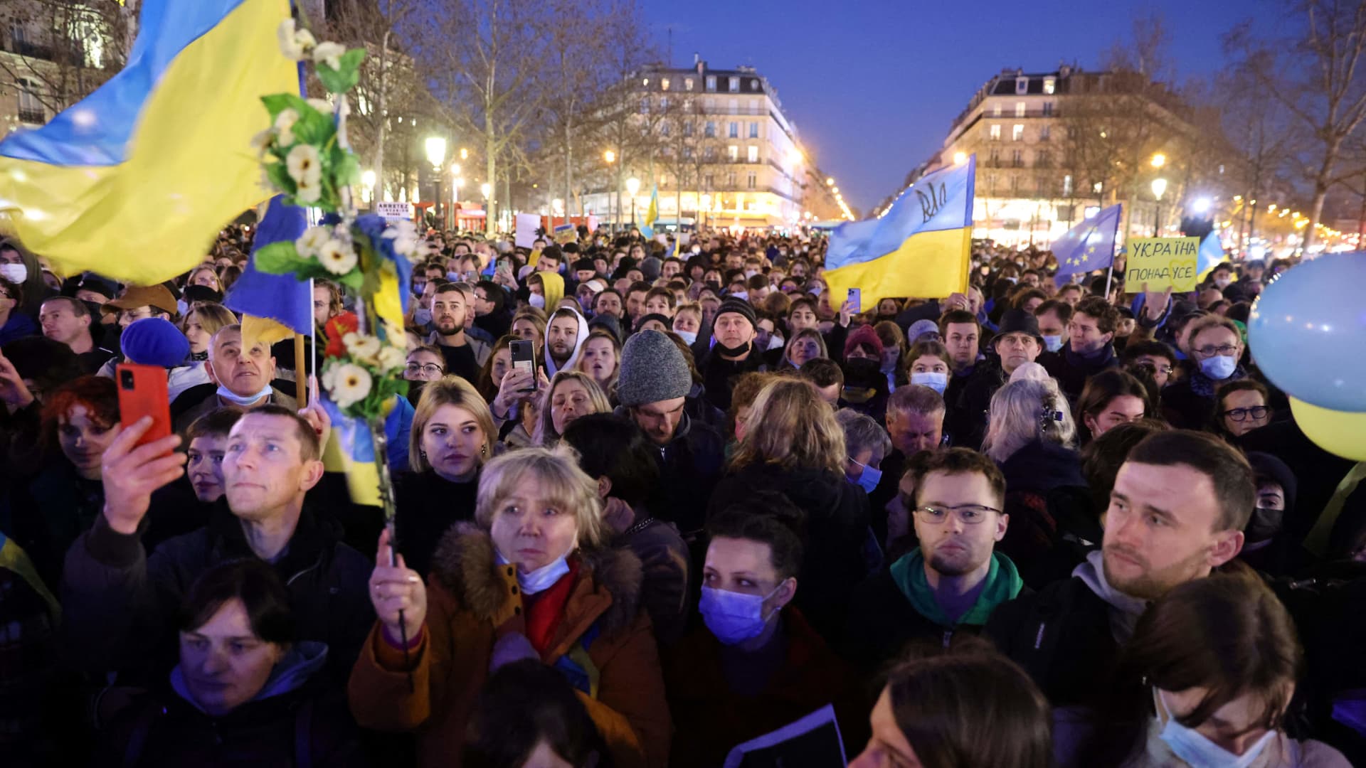 Protesters attend a demonstration called by the Union of Ukrainians in Franceand others associations on Republique square in Paris on February 24, 2022.