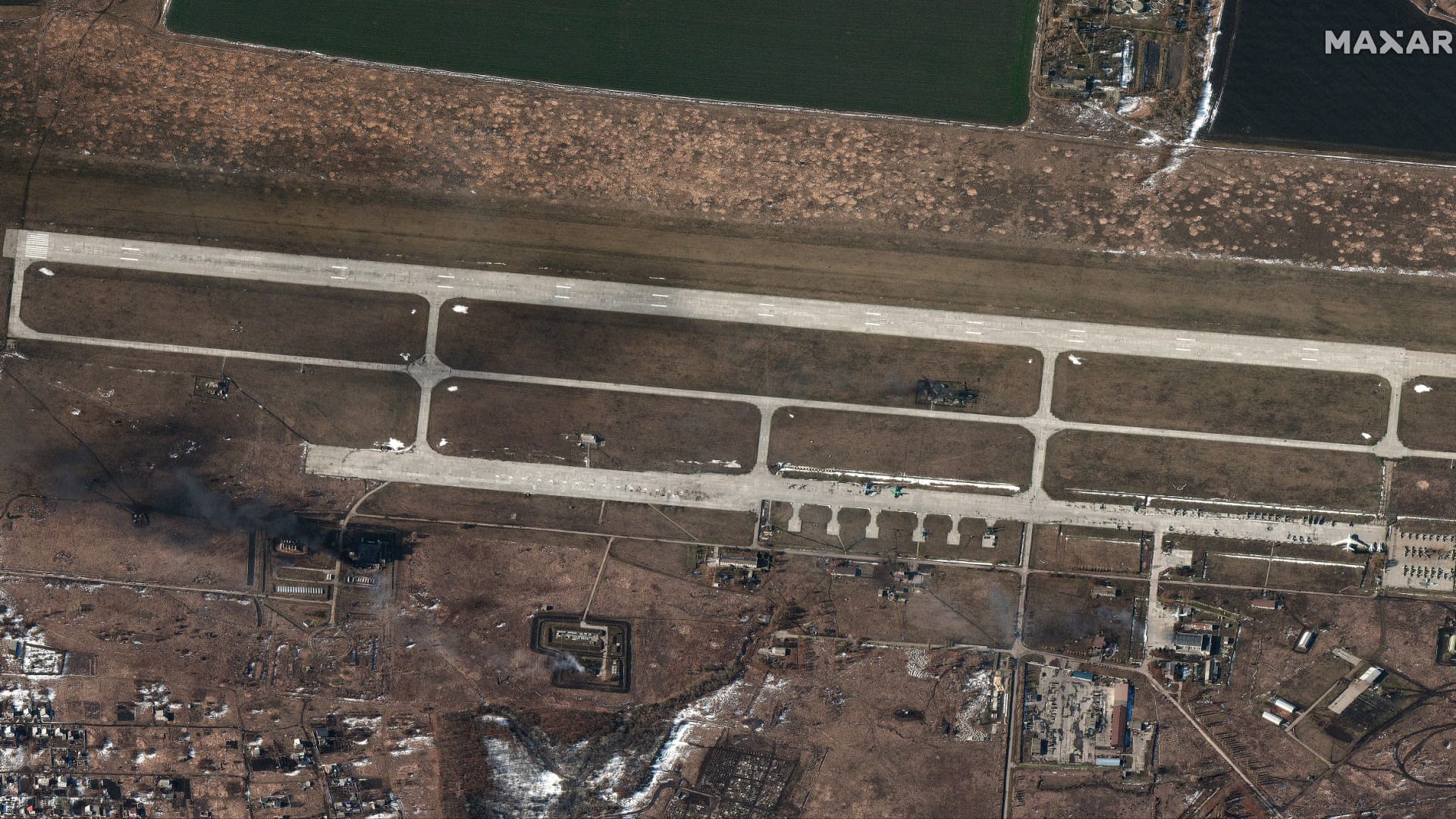 Satellite imagery captured on Feb. 24, 2022 reveals damage to fuel storage areas and other airport infrastructure at the Chuhuiv airfield.
