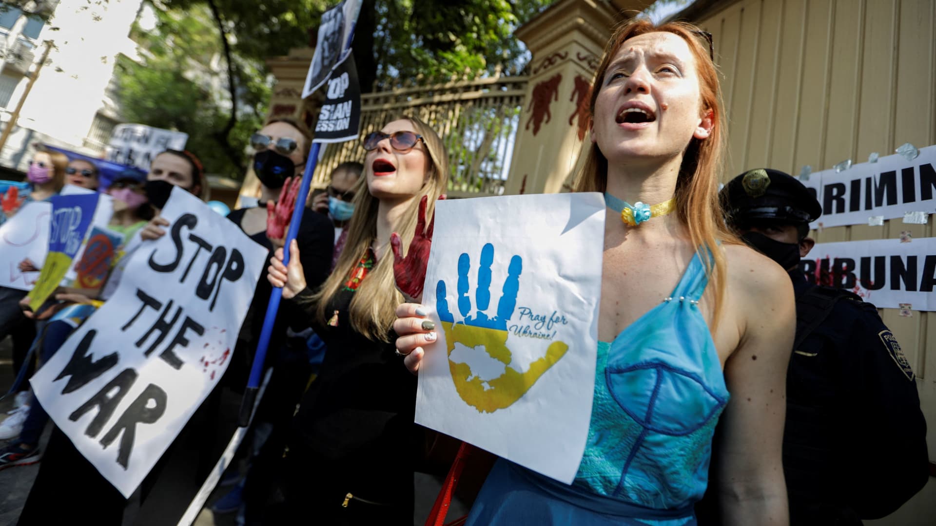 People hold signs in a protest after Russia launched a massive military operation against Ukraine, outside at Russia embassy in Mexico City, Mexico February 24, 2022.