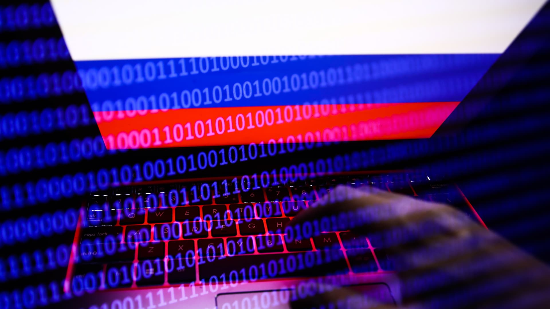 The Russian flag displayed on a laptop screen with binary code code overlaying.