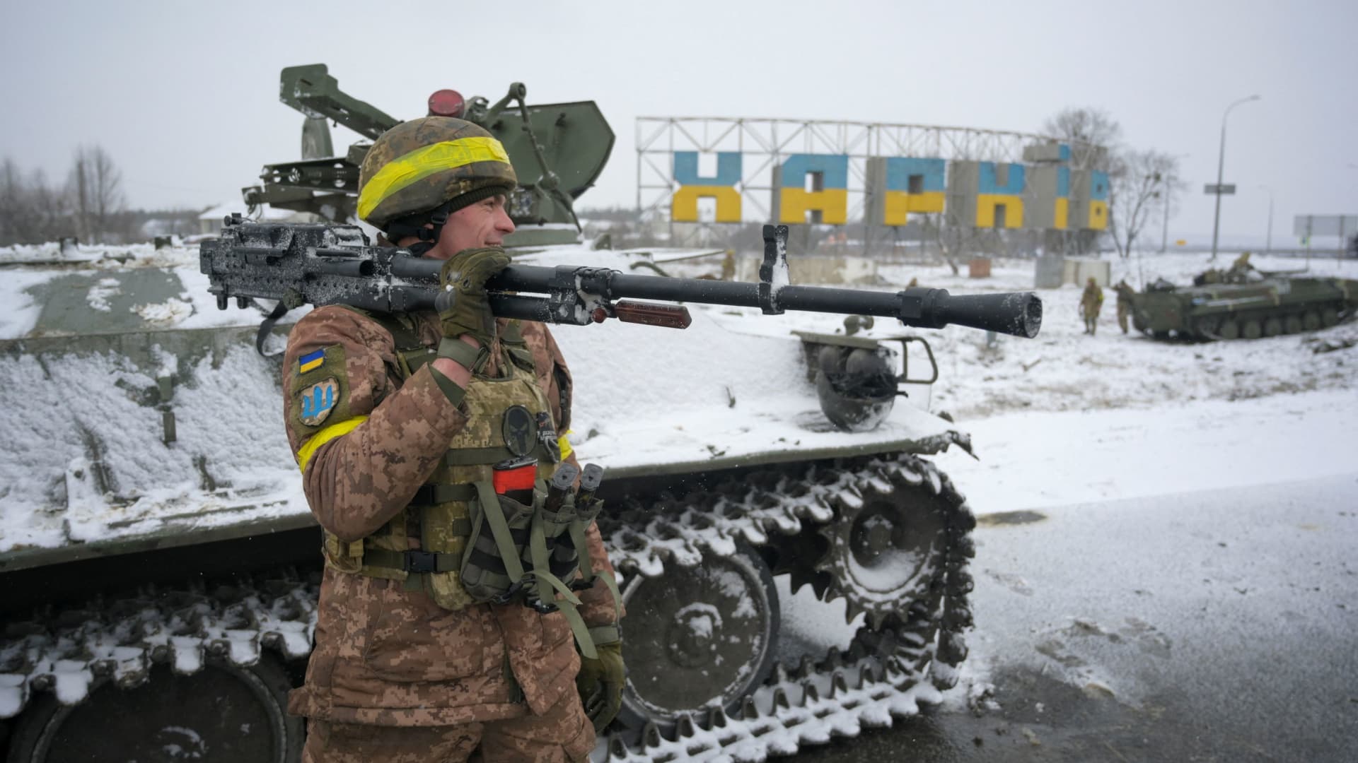A Ukrainian serviceman reacts while holding a weapon in Kharkiv, Ukraine February 25, 2022.