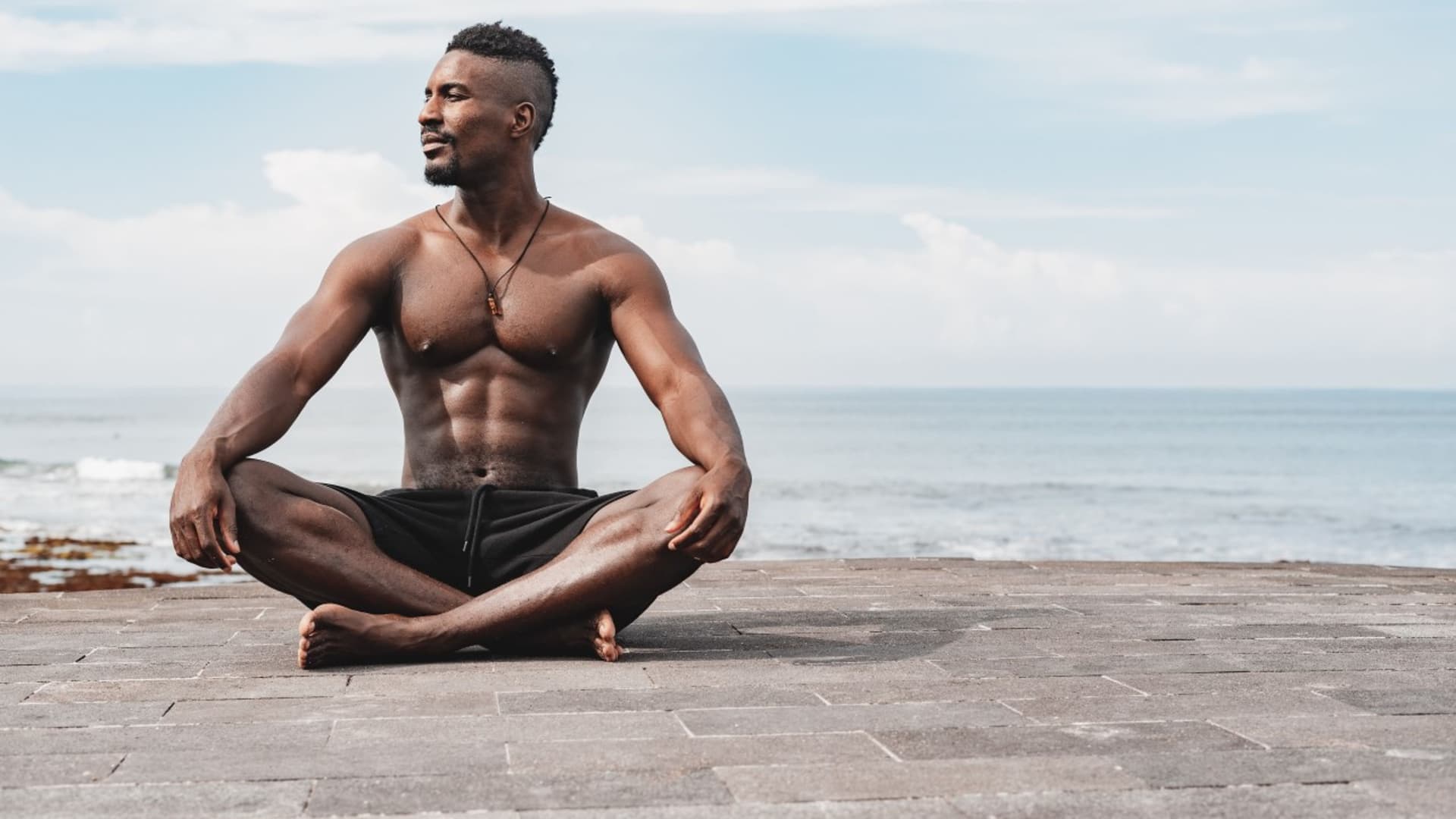 Olumide Gbenro meditating on the beach in Bali