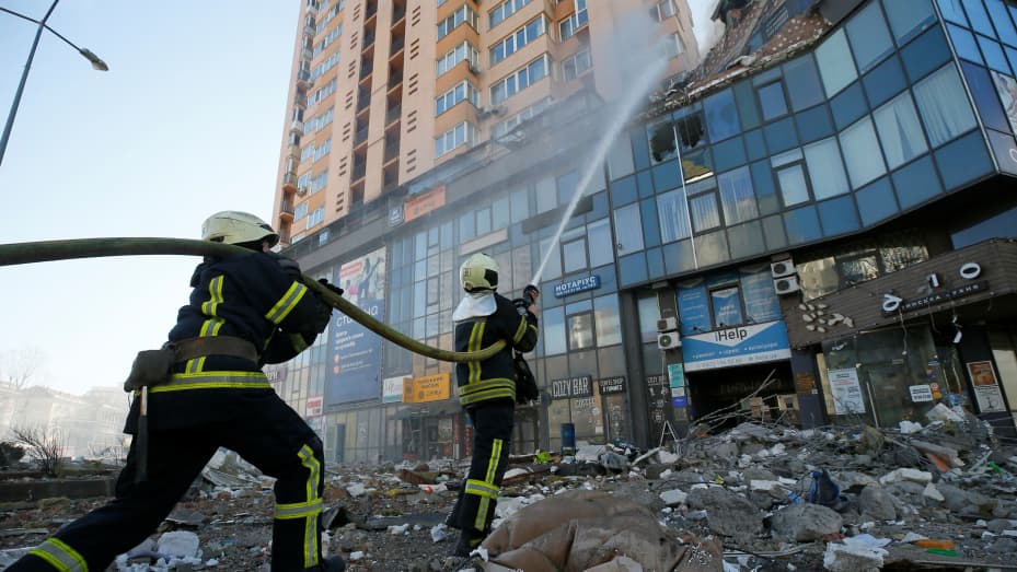 Firefighters extinguish fire in an apartment building damaged by recent shelling in Kyiv, Ukraine February 26, 2022.