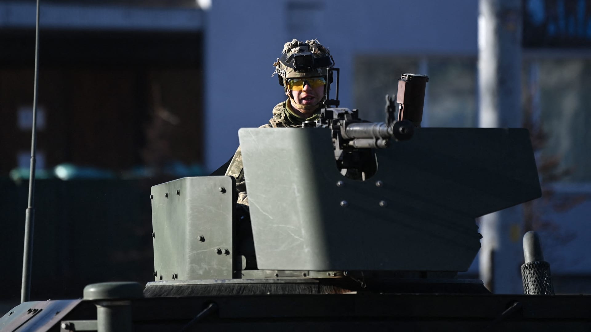 A Ukrainian soldier in an armoured vehicle waits on the west side of the Ukrainian capital of Kyiv on February 26, 2022.