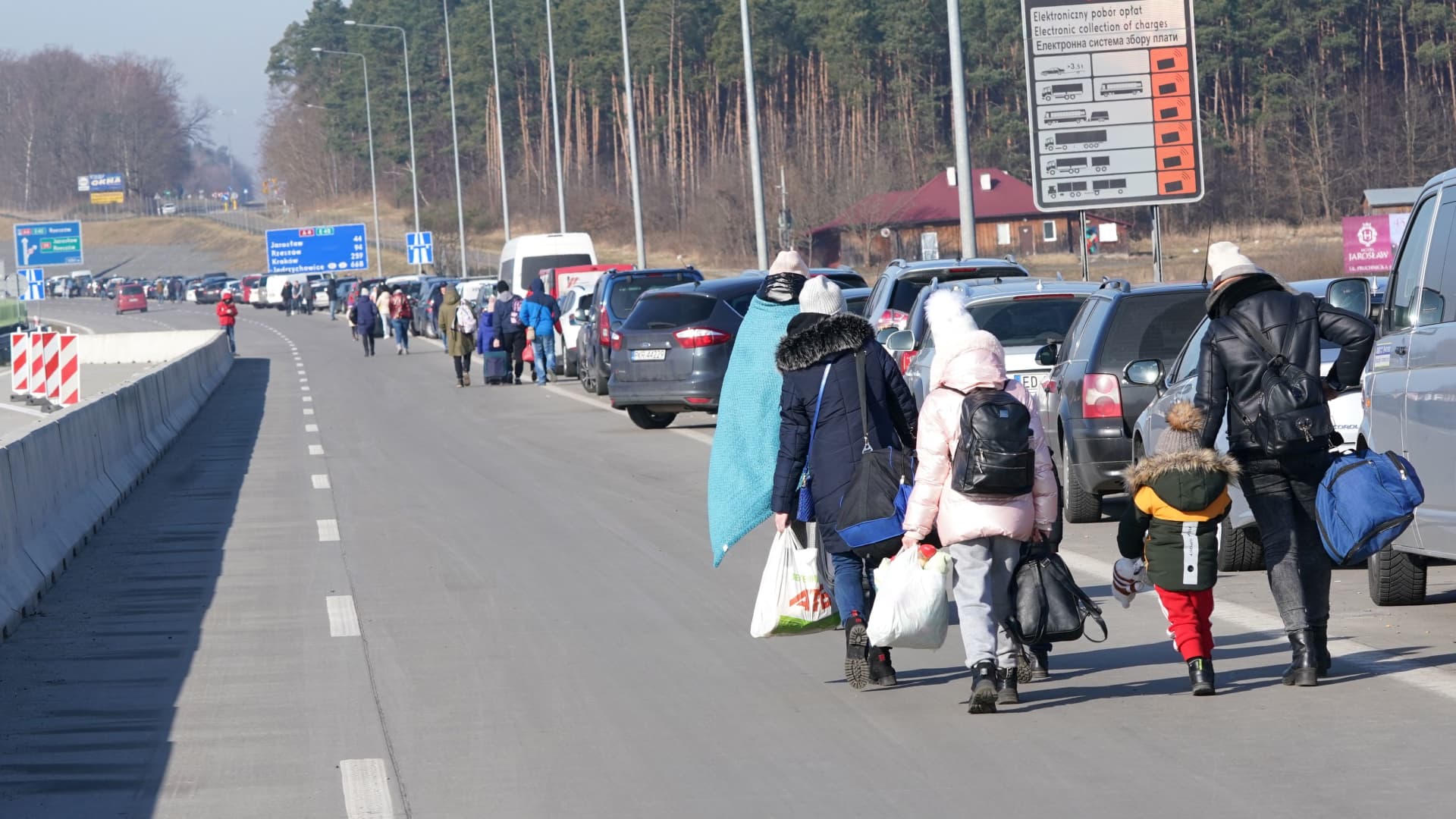 Ukrainian women and children cross the border from Ukraine to Poland at the Korczowa-Krakovets border crossing on February 26, 2022, following the Russian invasion of Ukraine.