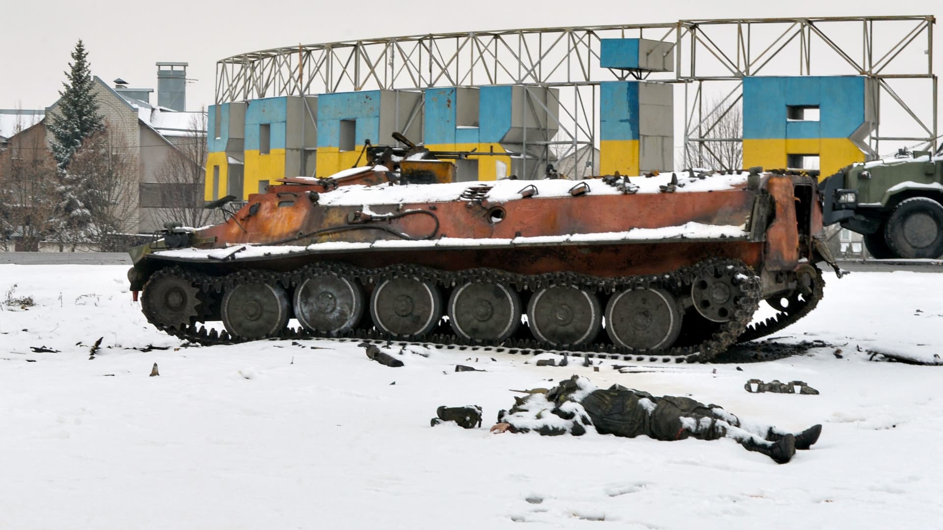 The body of a Russian serviceman lies near destroyed Russian military vehicles on the roadside on the outskirts of Kharkiv on February 26, 2022, following the Russian invasion of Ukraine.