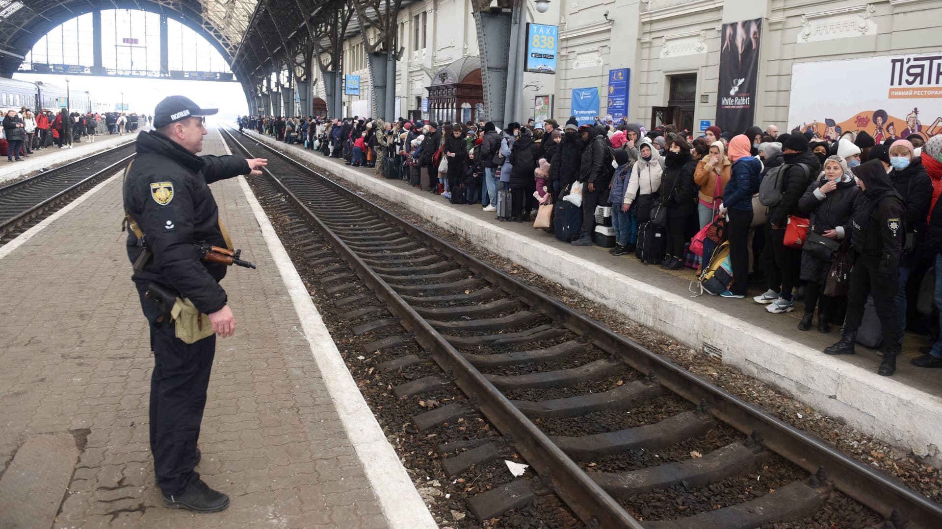 People wait for a train to Poland at the railway station of the western Ukrainian city of Lviv on February 26, 2022.