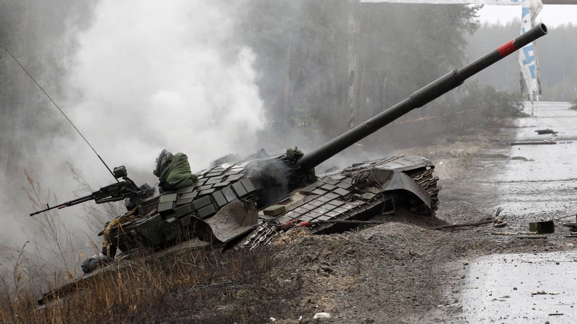 Smoke rises from a Russian tank destroyed by the Ukrainian troops on the side of a road in Lugansk region on February 26, 2022.