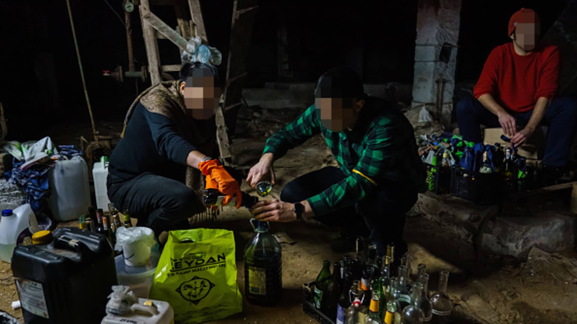 Volunteers from the Territorial Defense Units make Molotov cocktails to use against the invading Russian troops in Kyiv, Ukraine, Saturday, Feb. 26, 2022.