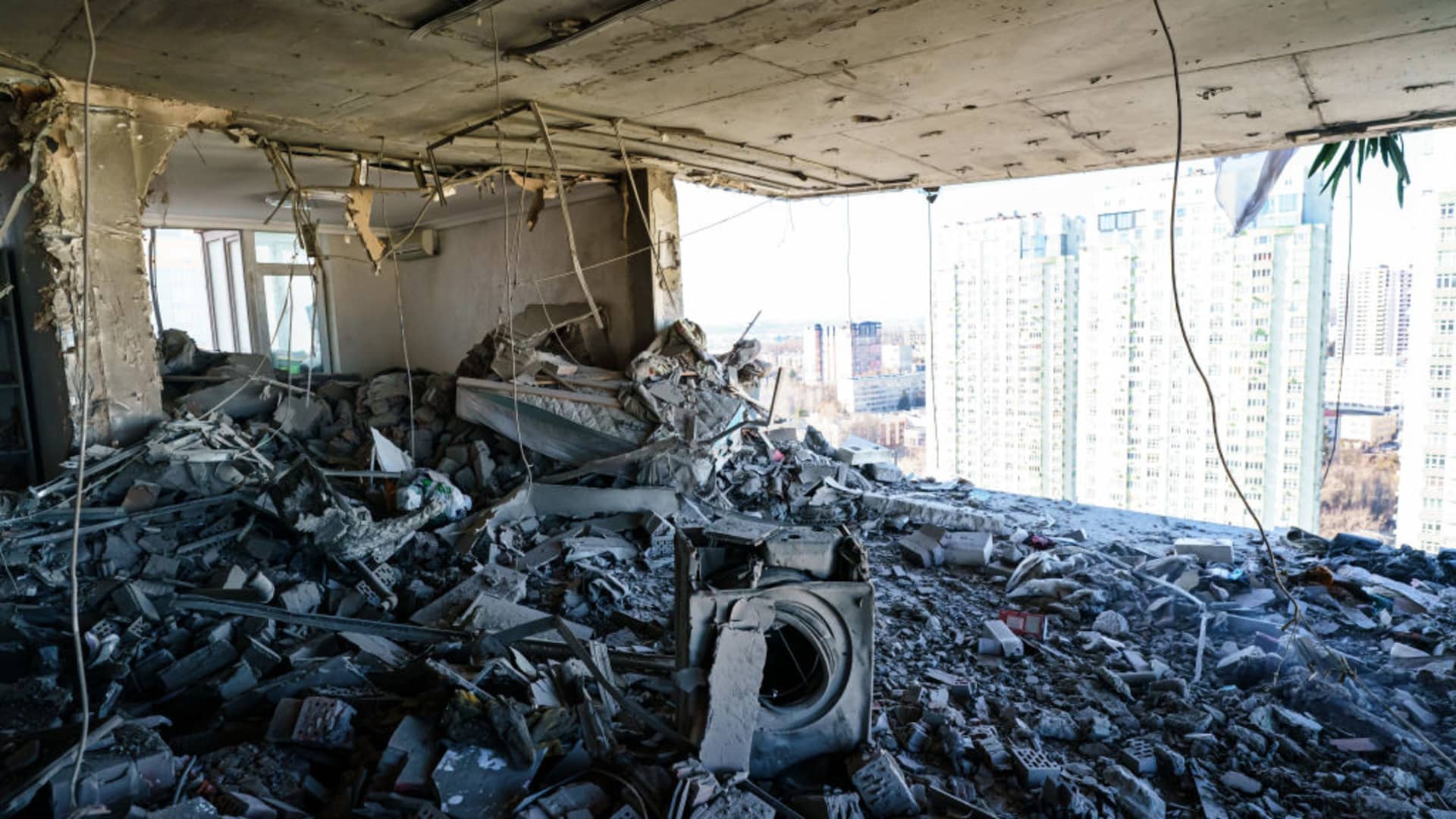 A rocket hits a residential building and destroys several floor of homes in Kyiv, Ukraine, Saturday, Feb. 26, 2022.