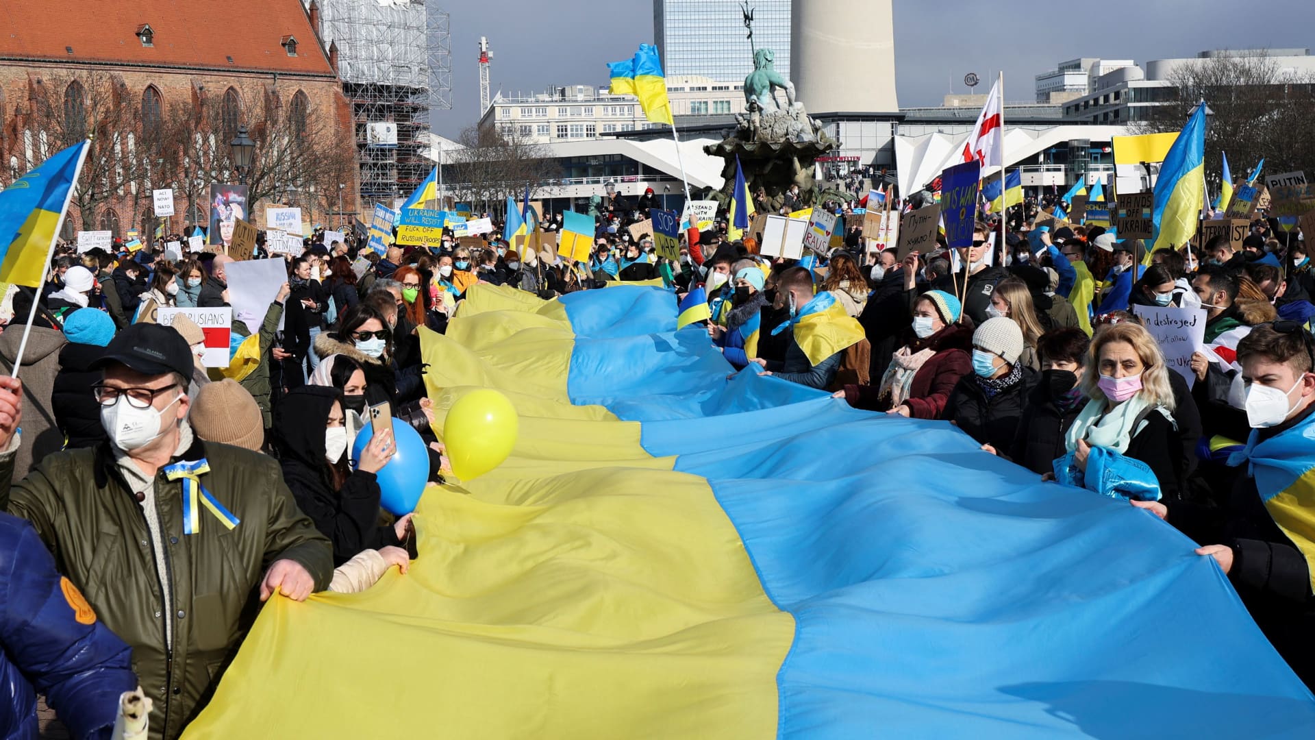 Demonstrators hold up a Ukrainian flag during an anti-war protest, after Russia launched a massive military operation against Ukraine, in Berlin, Germany, February 27, 2022.