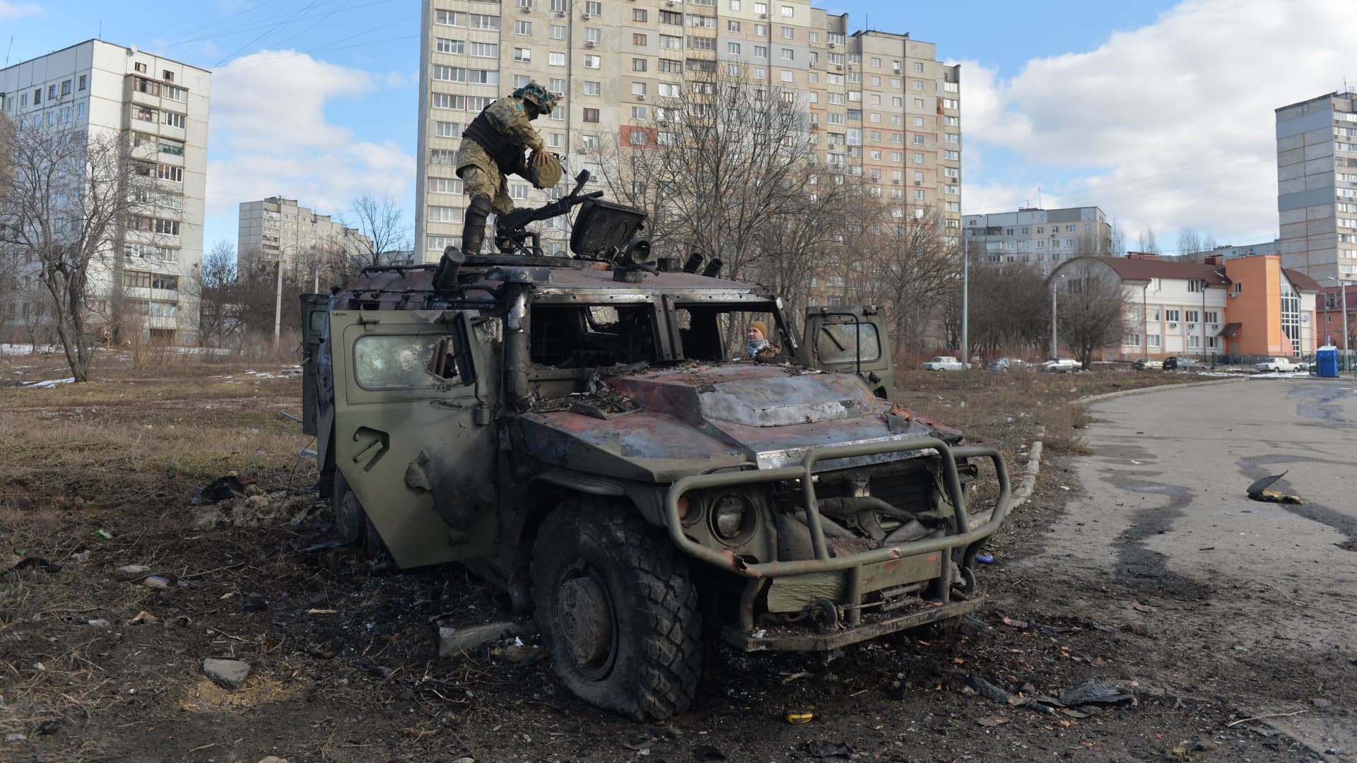 An Ukrainian Territorial Defence fighter examines a destroyed Russian infantry mobility vehicle GAZ Tigr after the fight in Kharkiv on February 27, 2022.