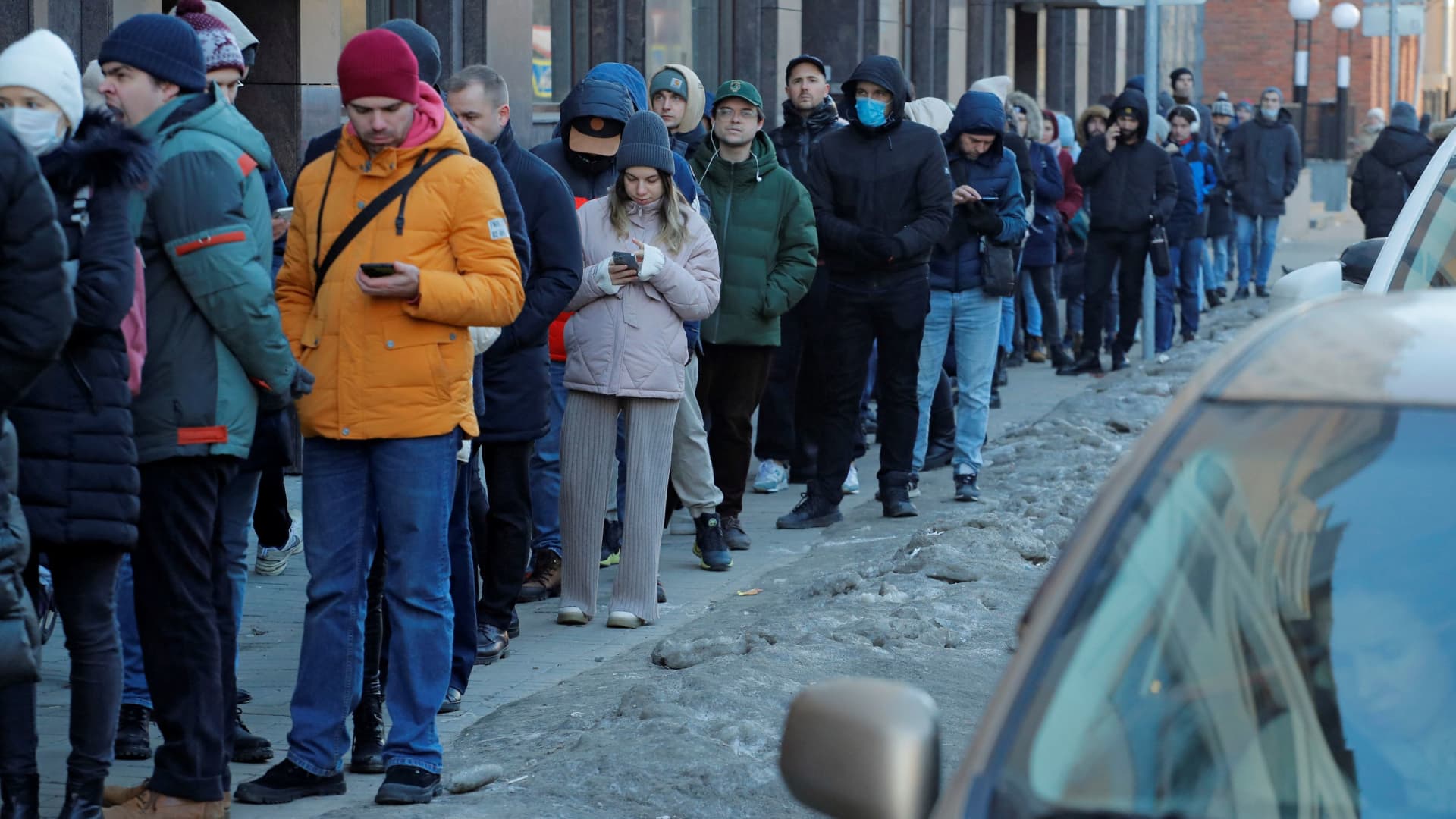 People stand in line to use an ATM money machine in Saint Petersburg, Russia February 27, 2022.