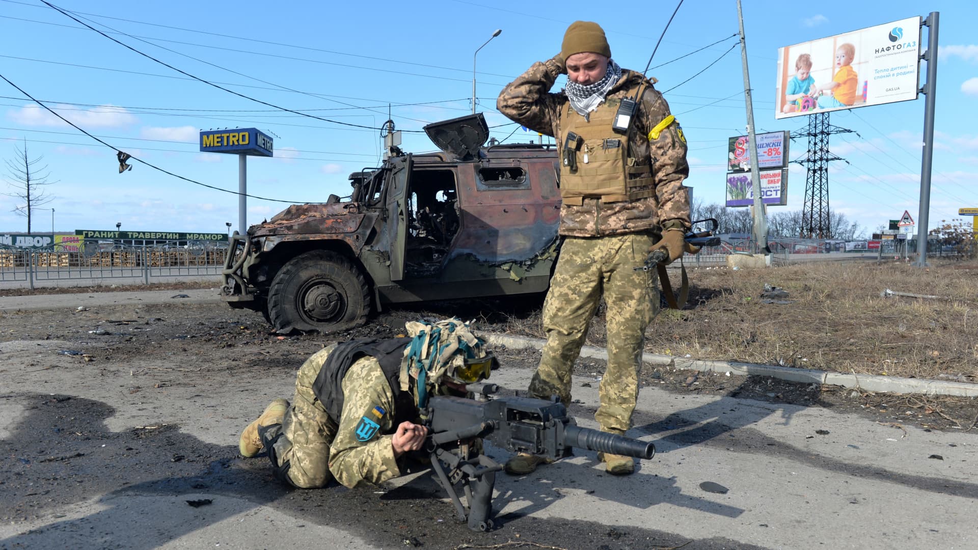 Ukrainian Territorial Defence fighters test the automatic grenade launcher taken from a destroyed Russian infantry mobility vehicle GAZ Tigr after the fight in Kharkiv on February 27, 2022.