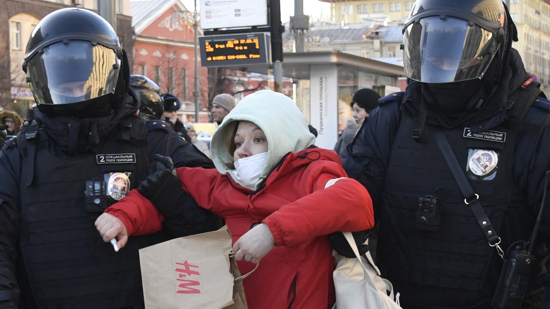 Police officers detain a woman during a protest against Russia's invasion of Ukraine in central Moscow on February 27, 2022.