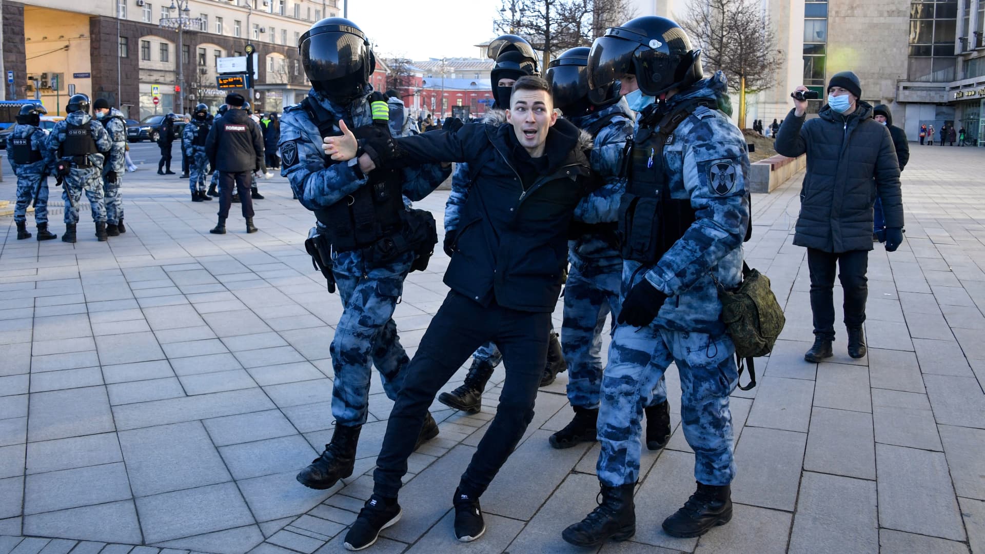 Police officers detain a man during a protest against Russia's invasion of Ukraine in central Moscow on February 27, 2022.