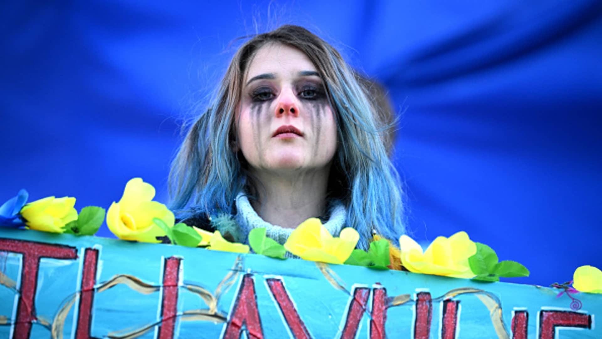 A protester who has been crying holds a banner during a demonstration in support of Ukraine in Trafalgar Square on February 27, 2022 in London, England.