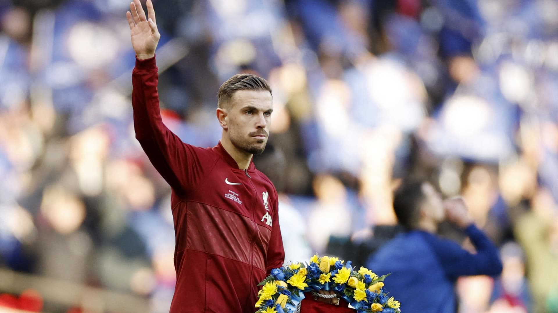 Soccer Football - Carabao Cup Final - Chelsea v Liverpool - Wembley Stadium, London, Britain - February 27, 2022 Liverpool's Jordan Henderson holds a wreath in support of Ukraine before the match