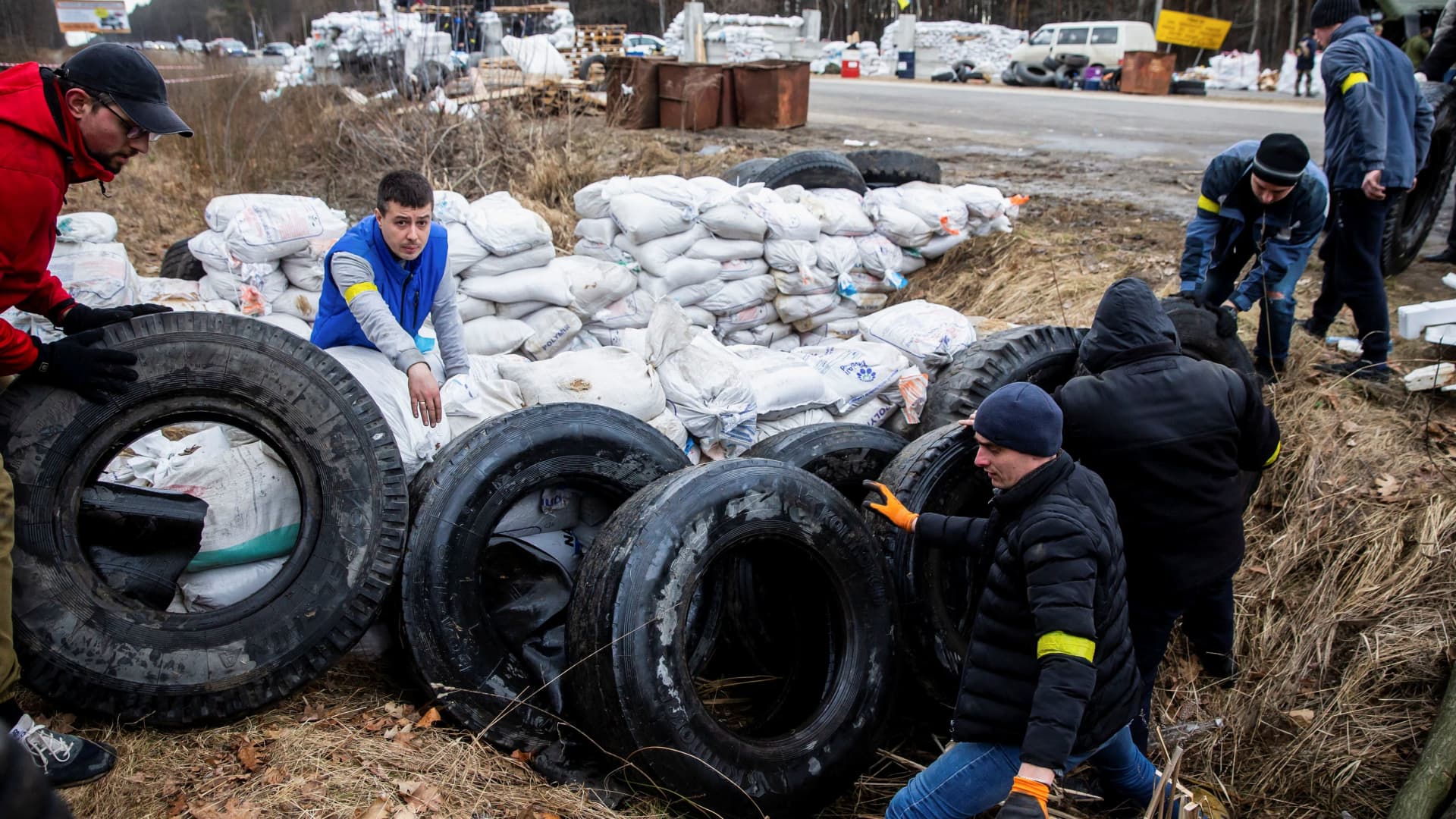 Members of the Ukrainian Territorial Defence Forces reinforce the checkpoint with tires, after Russia launched a massive military operation against Ukraine, in the city of Zhytomyr, Ukraine February 27, 2022.