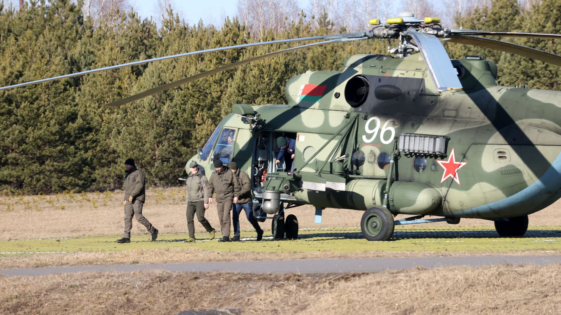 Members of the Ukrainian delegation disembark from a helicopter as they arrive for talks with Russian representatives in the Gomel region, Belarus February 28, 2022.