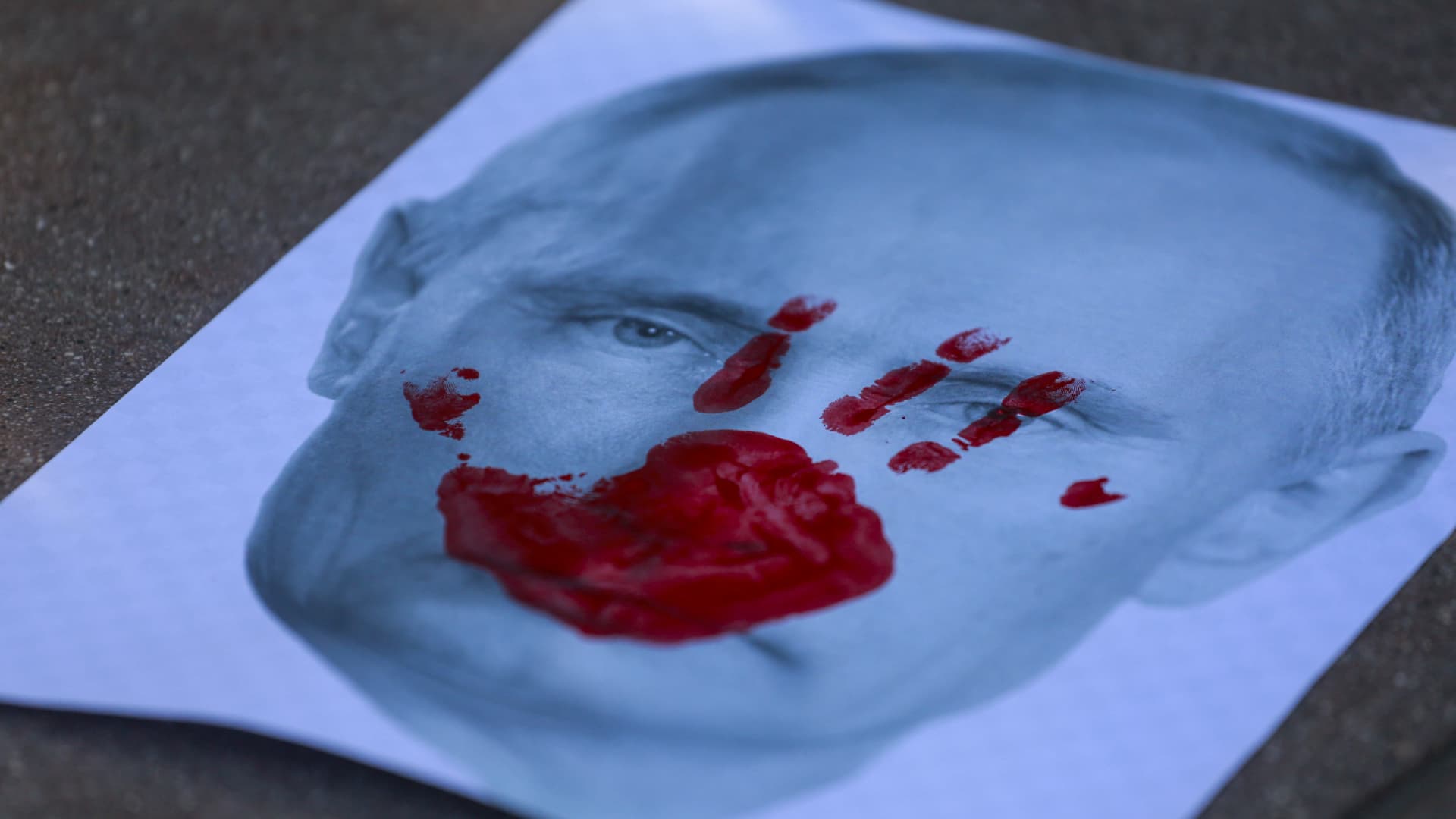 A placard showing a picture of Russian president Vladimir Putin with a red hand print during a rally in support of Ukraine in Santa Monica, California, on February 27, 2022.