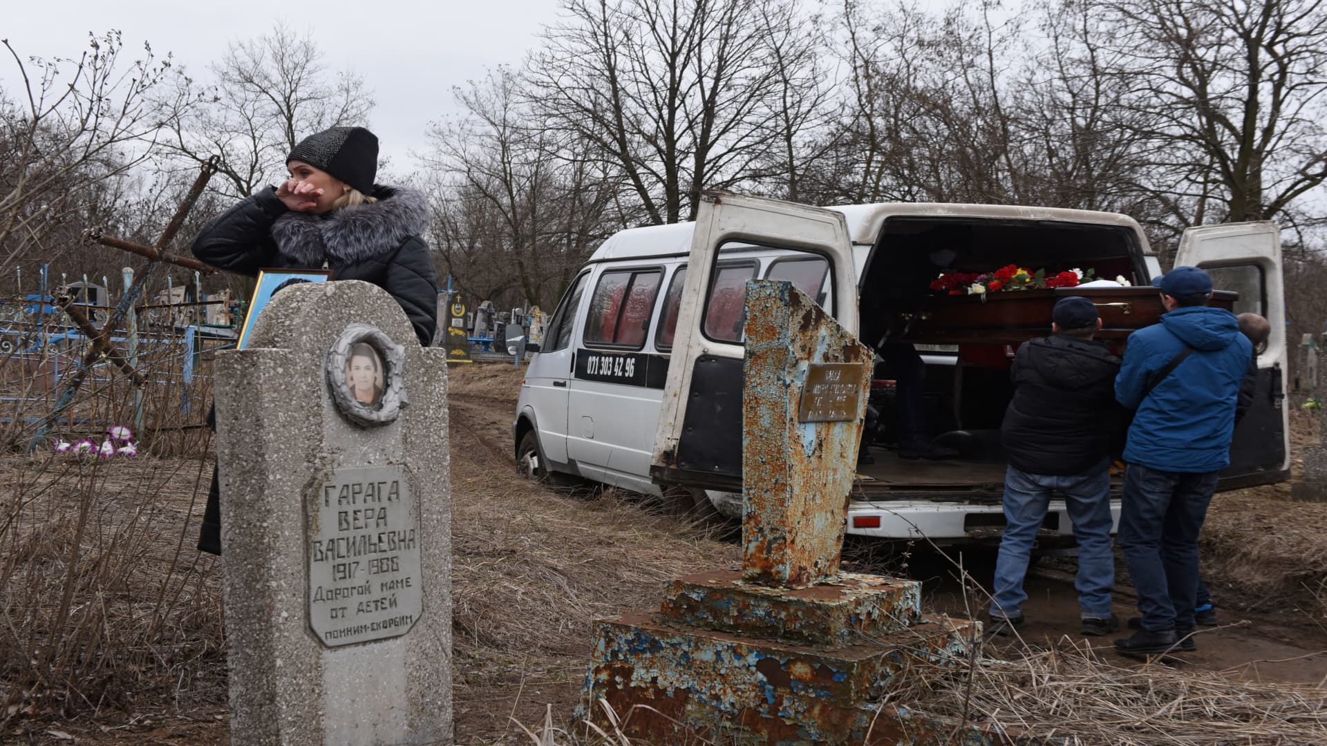 Men unload the coffin from a vehicle during a funeral of school teachers Yelena Ivanova and Yelena Kudrik, who were killed by shelling, at a cemetery in the separatist-controlled town of Horlivka (Gorlovka) in the Donetsk region, Ukraine, February 28, 2022. 