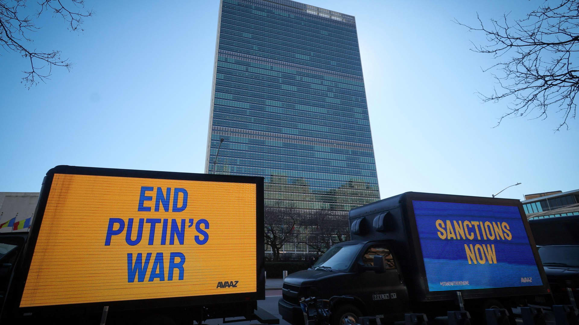 Trucks display electronic messages while protestors demonstrate outside United Nations headquarters, as inside diplomats hold an emergency session of the 193-member U.N. General Assembly on Russia's invasion of Ukraine, in Manhattan in New York City, February 28, 2022.