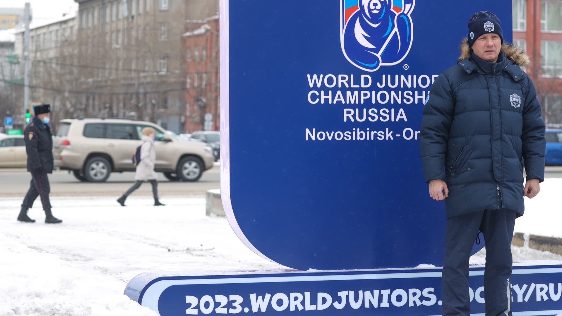 A man poses in front of the 2023 IIHF World Junior Championship countdown clock set going in the Teatralny garden square; the 47th edition of the World Juniors is scheduled to start in Russia's Siberian cities of Novosibirsk and Omsk on December 26, 2022, and last until January 5, 2023.