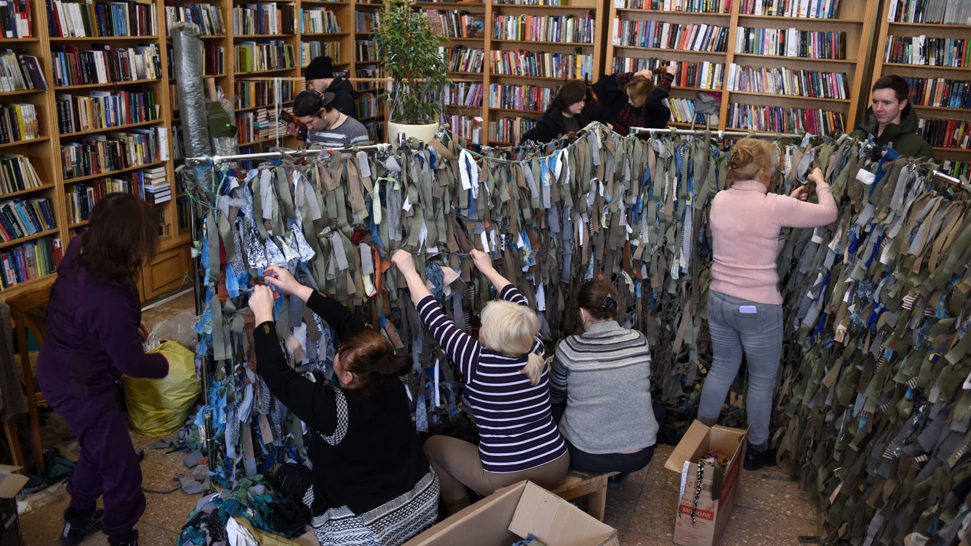Volunteers make camouflage nets for the Ukrainian military at a library in western Ukrainian city of Lviv on March 1, 2022.
