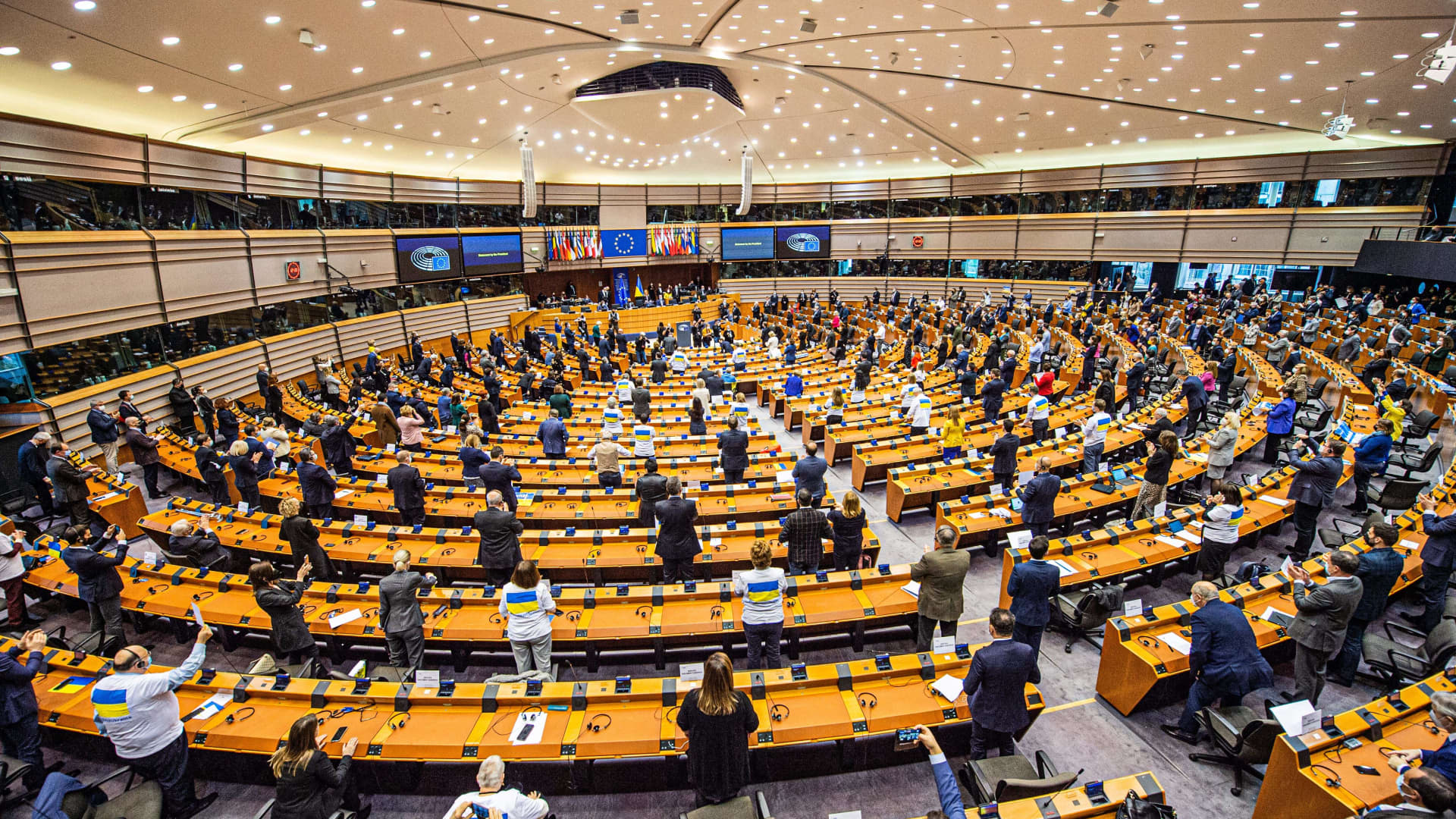 Parliament members give a standing ovation after a live video address of Ukrainian President Volodymyr Zelenskyy, during an extraordinary plenary session of the European parliament on Russian invasion of Ukraine, in Brussels, on March 1, 2022.