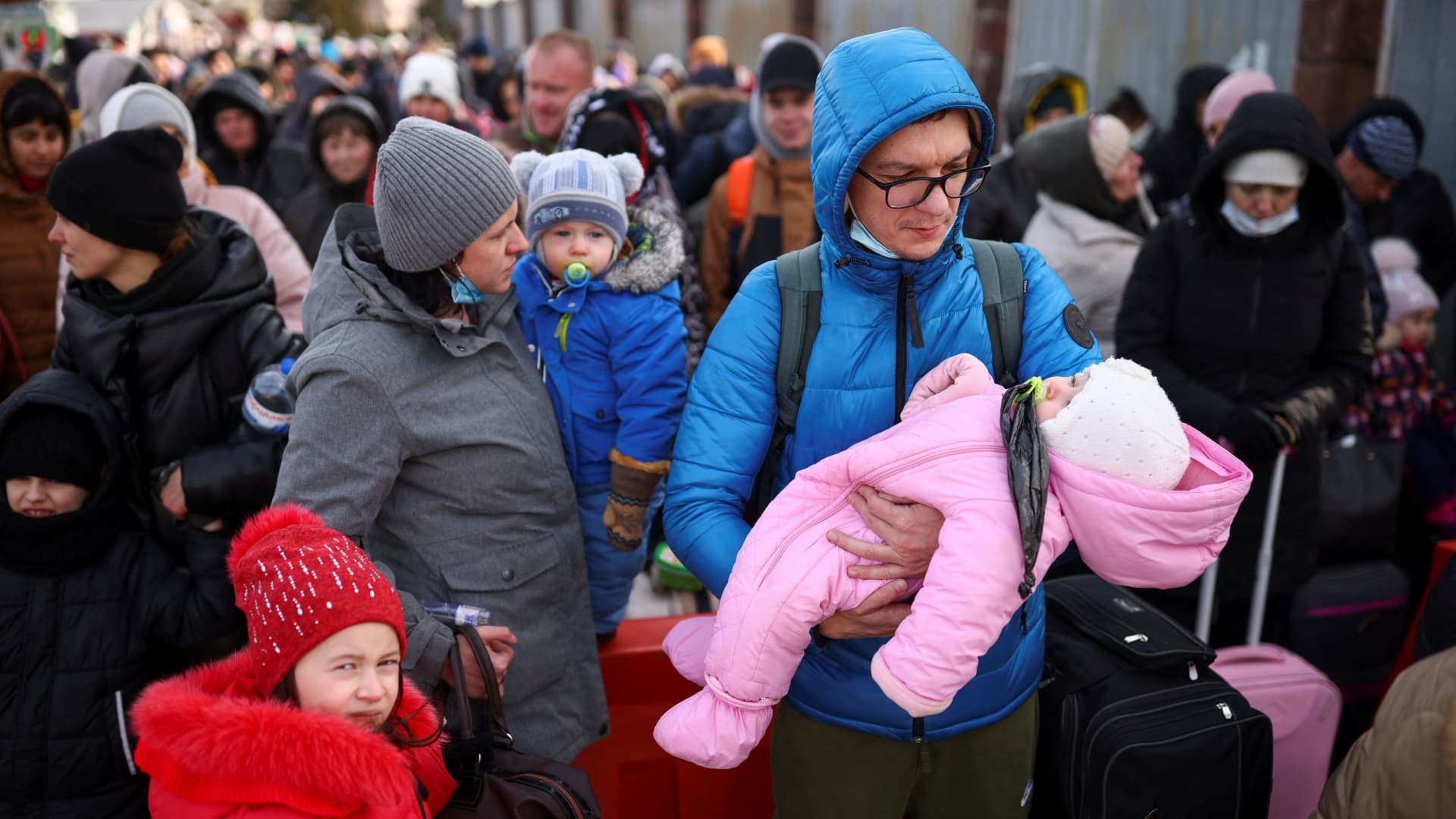 People who have fled Russia's invasion of Ukraine wait at the Shehyni border crossing to enter Poland, near Mostyska, Ukraine, on March 1, 2022.