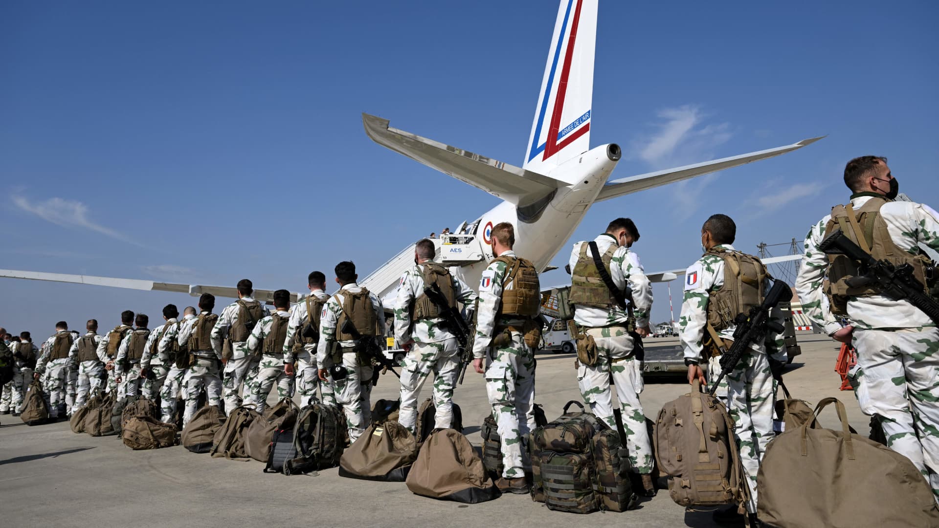 French soldiers of the 27th Bataillon des chasseurs alpins queue as they board an Airbus A330 MRTT at the French air force base of Istres, southern France on March 1, 2022, before taking off for Romania.