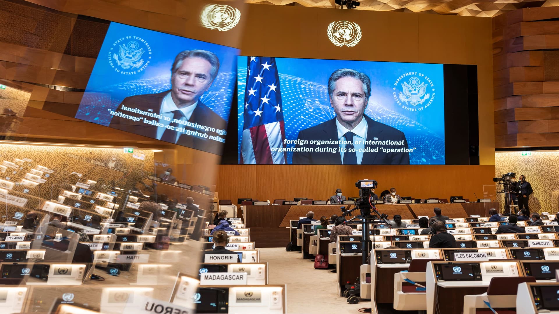 U.S. Secretary of State Antony Blinken appears on a screen as he delivers a speech during the 49th session of the UN Human Rights Council at the European headquarters of the United Nations in Geneva, Switzerland, March 1, 2022.